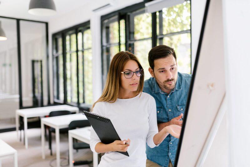 couple staring at a board