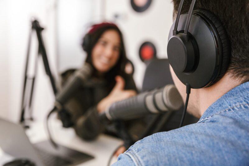 Man and woman talking in mics