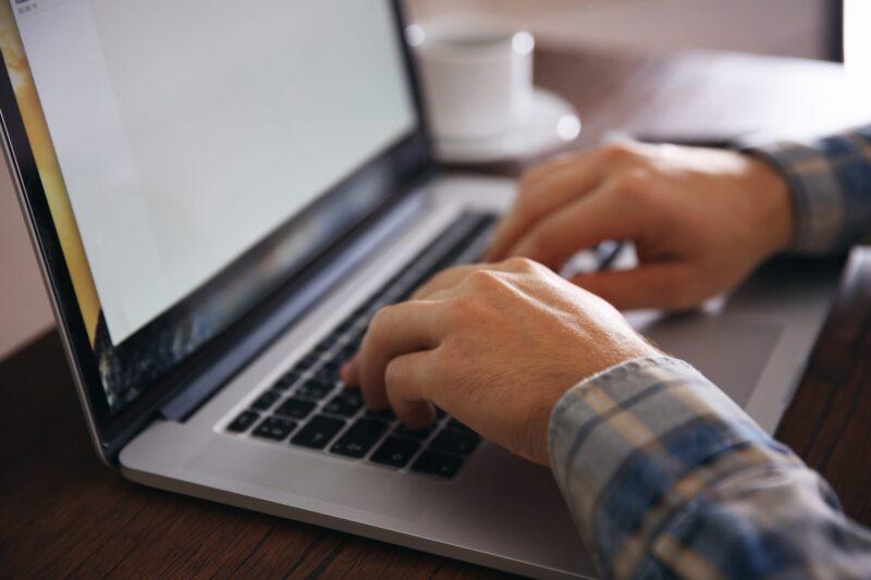 Person typing on laptop