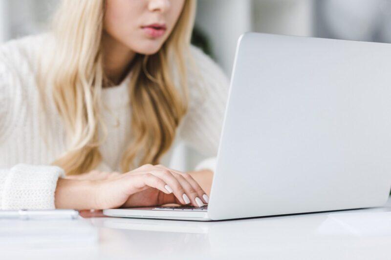 Person using white laptop