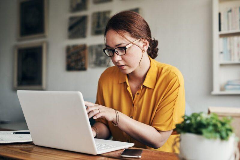 Woman pointing at laptop screen