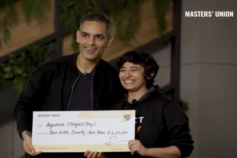 Ankur Warikoo and Dyumna Madan holding grant cheque